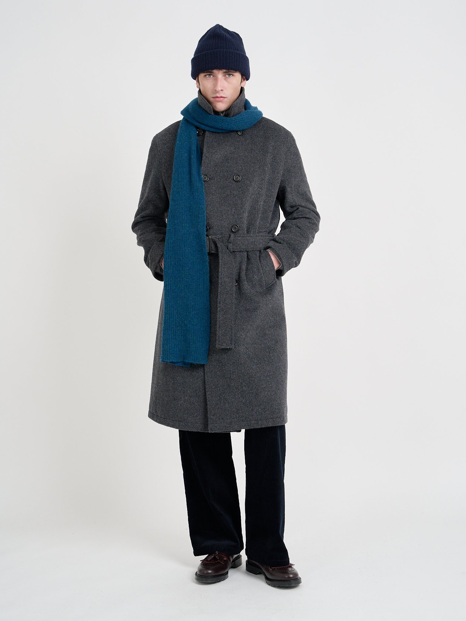 Model wearing Men's Charcoal Recycled Wool And Mohair Trench Coat with a Blue Scarf