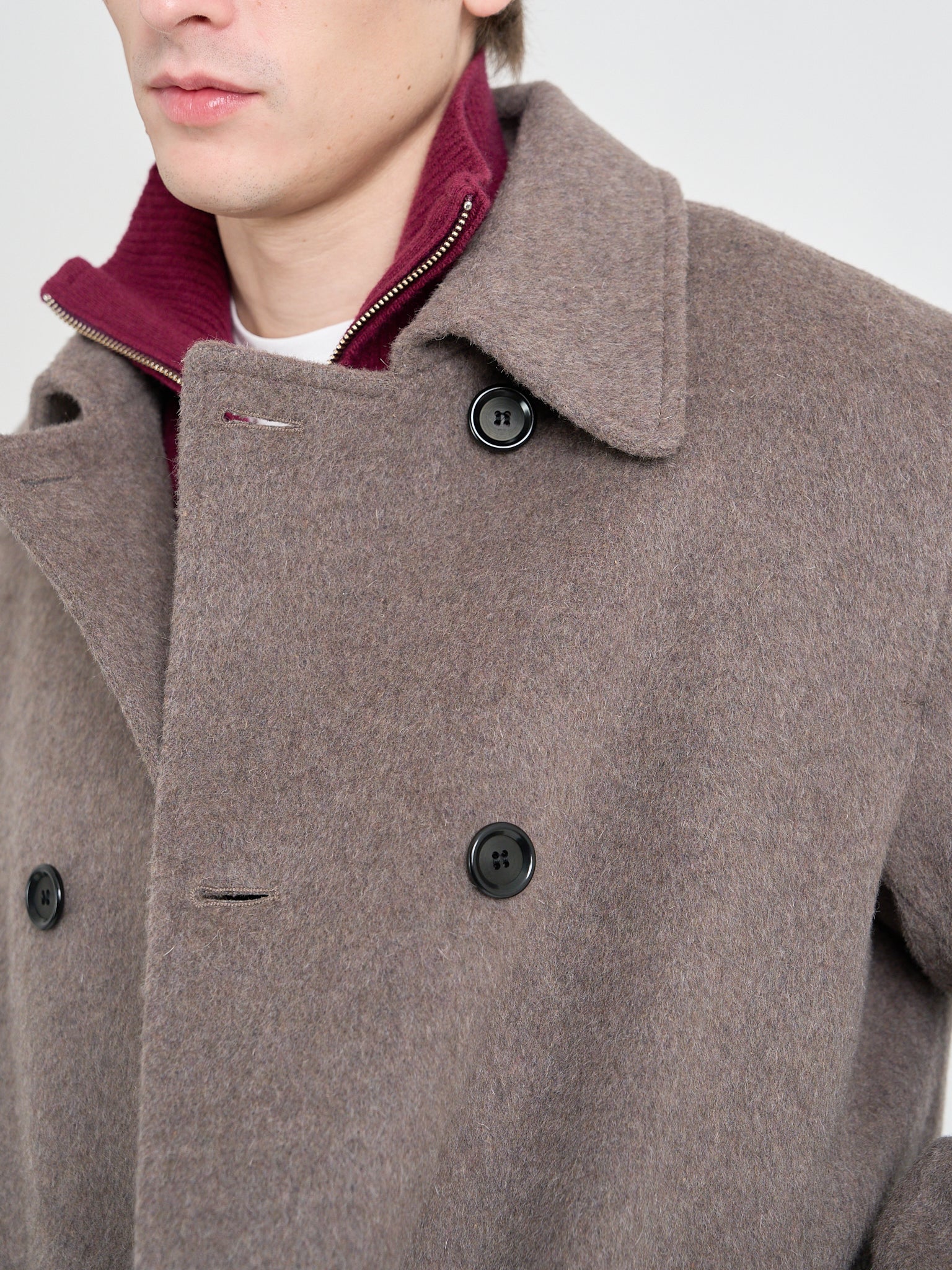 Detailed collar shot of model wearing Oliver Spencer Men's Taupe Double-Breasted Wool Trench Coat.