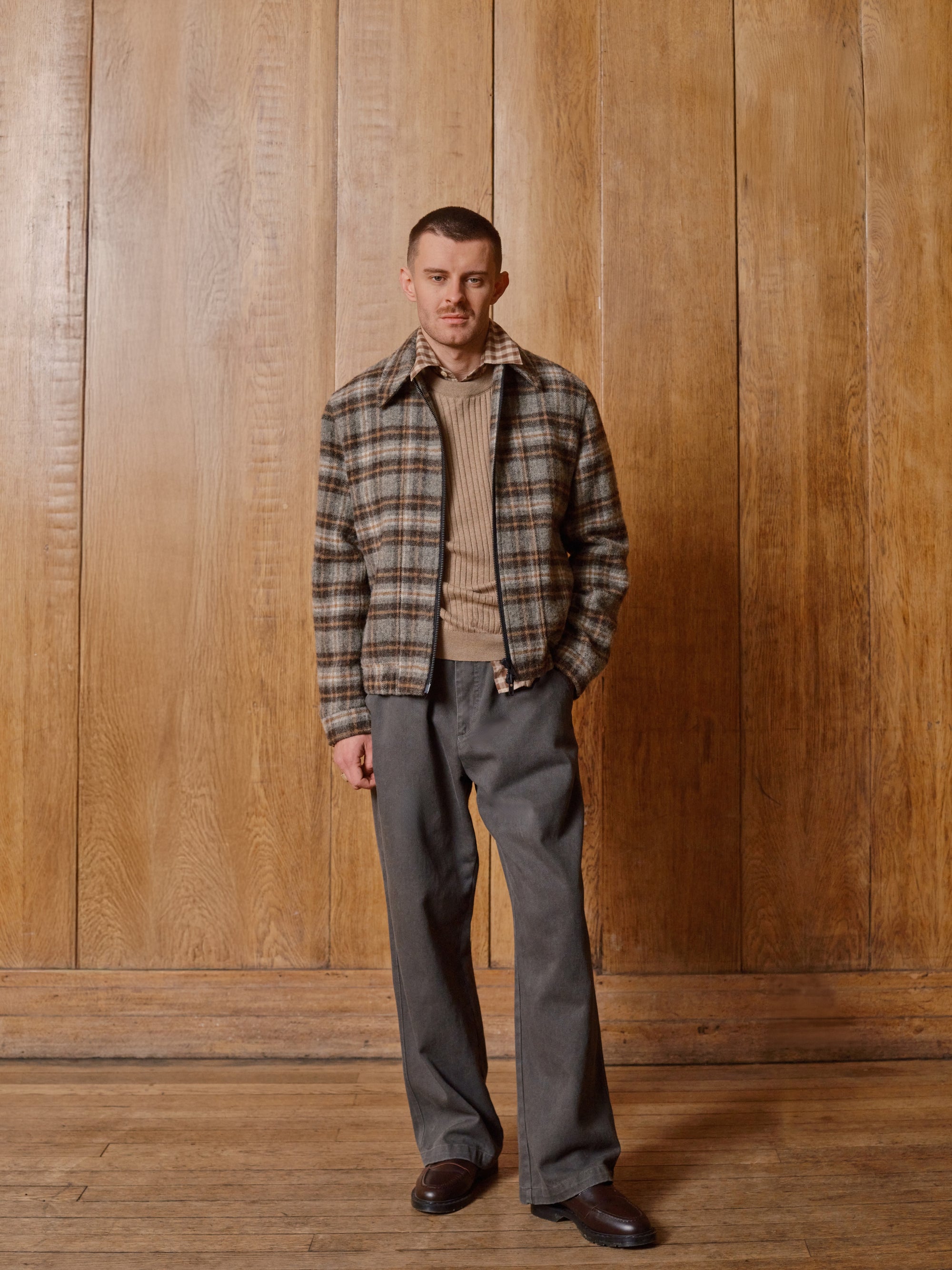 Model in a check bomber and sand jumper
