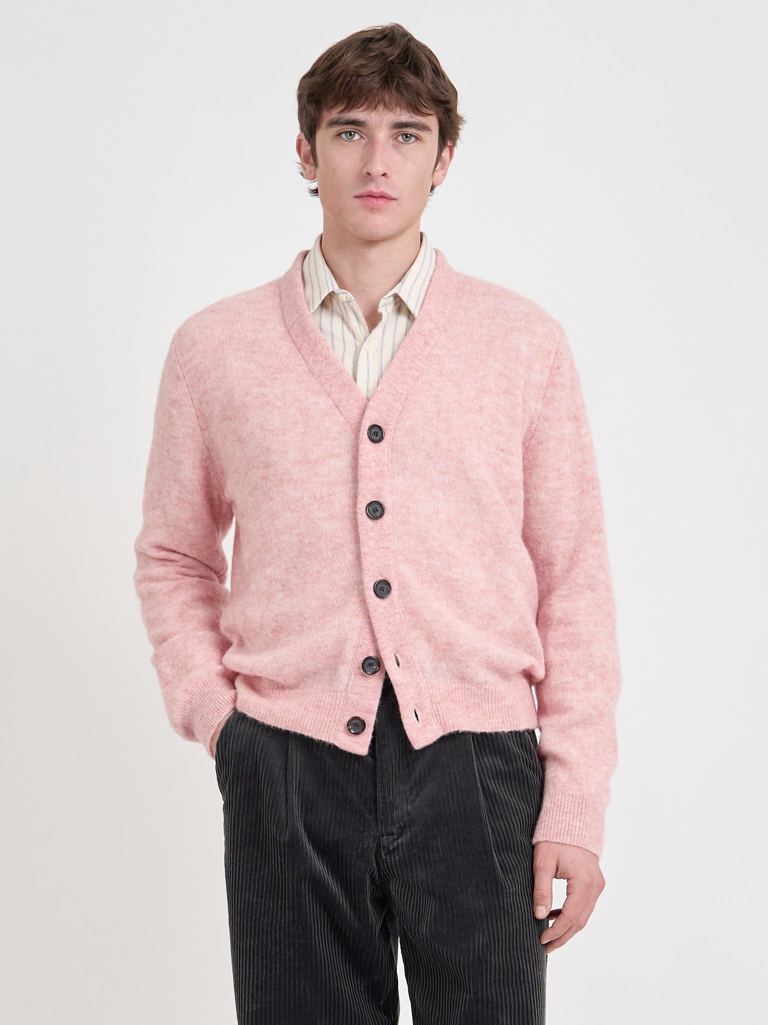 Model wearing a Oliver Spencer pink cardigan over a white shirt