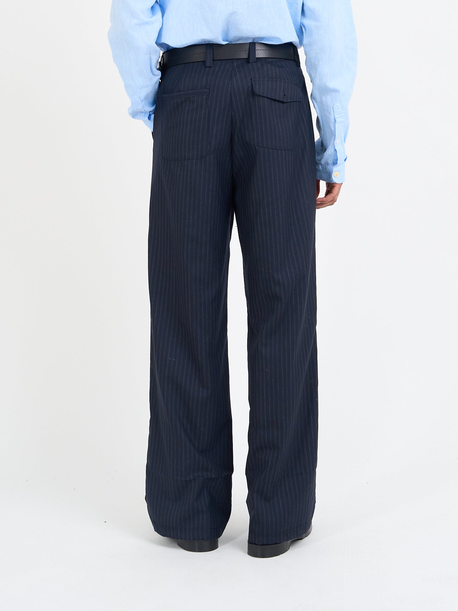 Orsman wide-leg navy pinstripe wool trousers worn on model, rear view